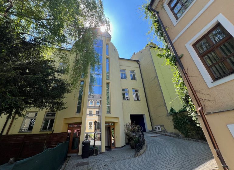 A building with a glass facade on a narrow street, Grösslingova, Bratislava - Old Town. Offices.