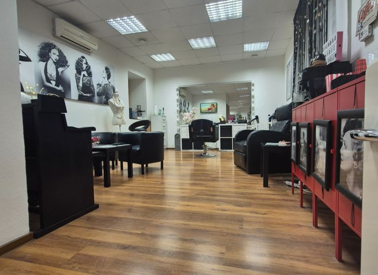 Interior of commercial spaces with wood-patterned flooring and interior furniture.