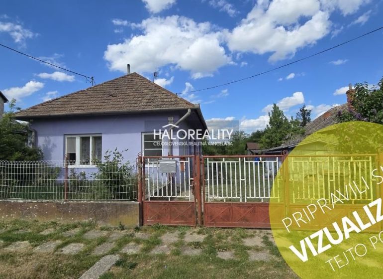 Purple family house in the vicinity of Lok with a fence and gate on a grassy street.