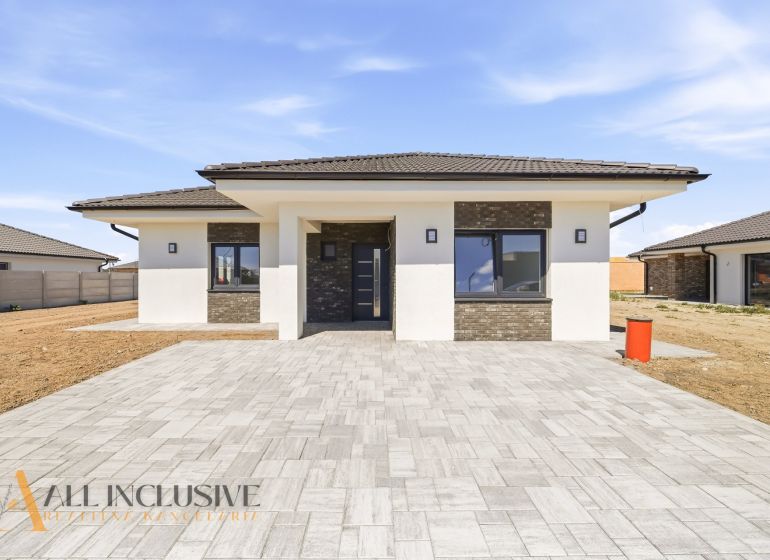 A family house in Hviezdoslavov with a paved courtyard and a contrasting facade.