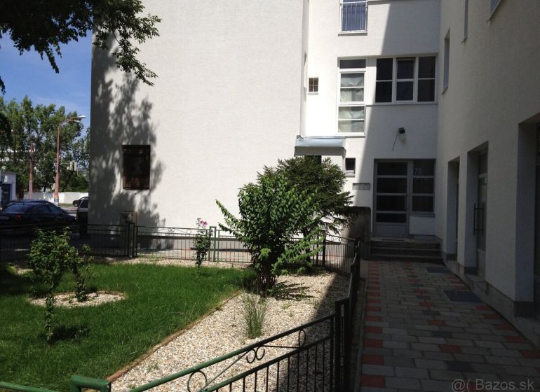 Entrance to the apartment building with a landscaped front garden on Vajnorská Street, Bratislava - Nové Mesto.