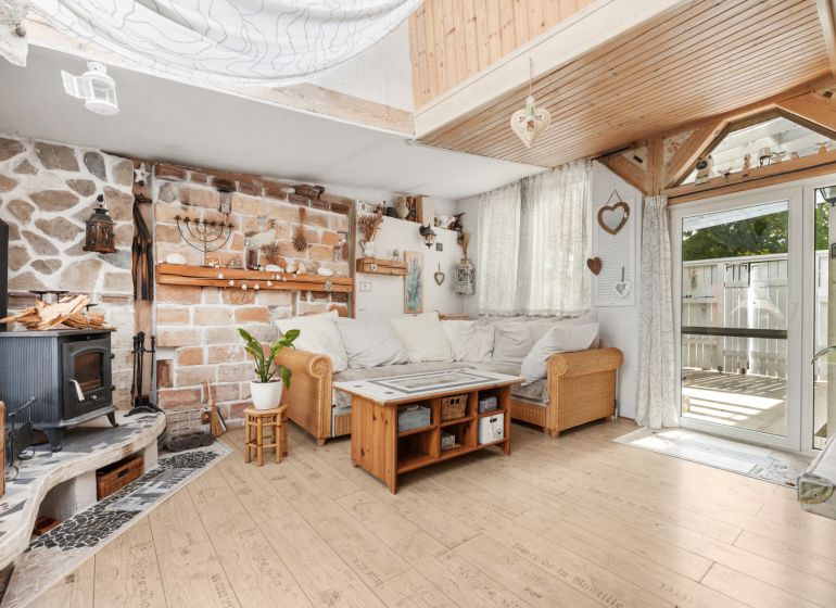 Living room in a family house with a fireplace and a wooden decor floor.