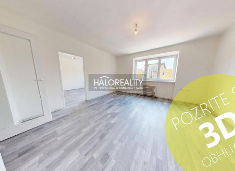 A bright room with a wooden decor floor in a 2-room apartment.