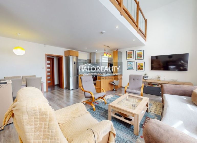 A family house with a wooden decor floor, spacious living room, and dining area.