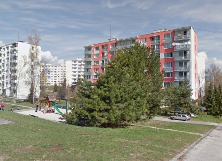 Housing estate scenery with a children's playground and apartment buildings in Fončorda, Banská Bystrica.