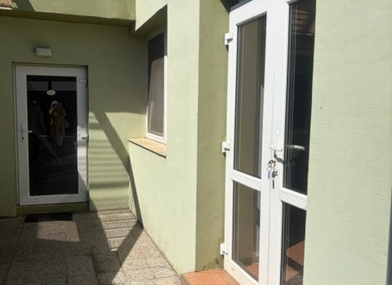 Entrance area of a 1-bedroom apartment on Záhradná Street in Pezinok with glass doors.