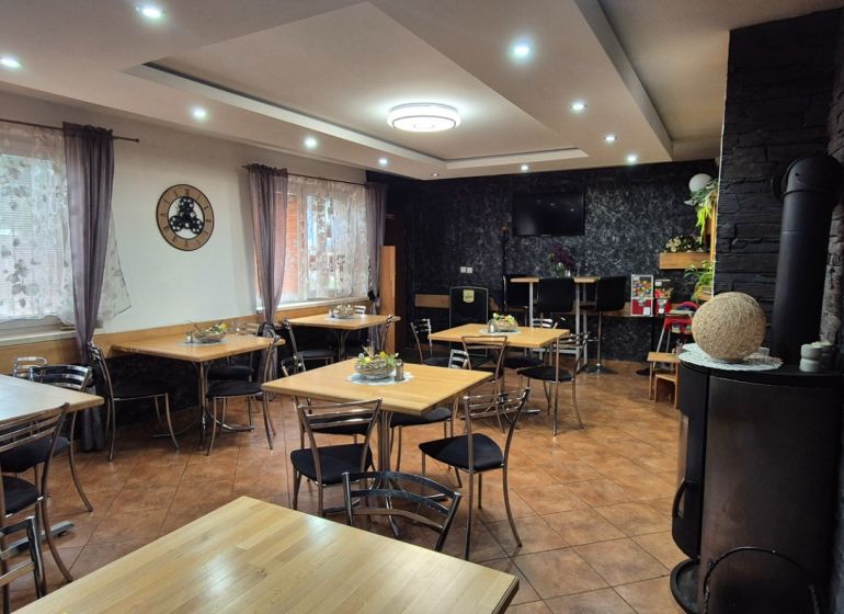 Commercial spaces with tables, chairs, and decorative curtains, with a wooden decor floor.