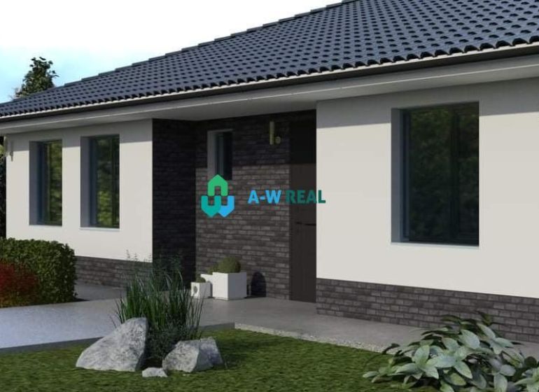 A family house in Povoda with a garden and a paved walkway, surrounded by flowers and shrubs.