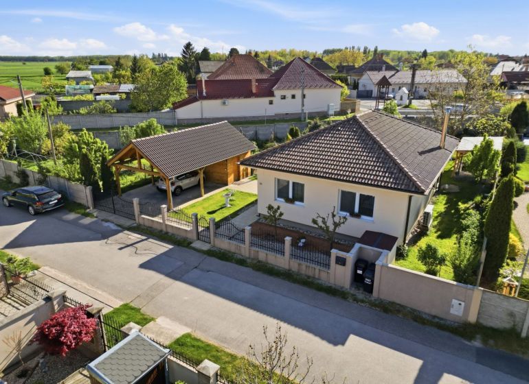 A family house in the village of Kostolné Kračany with a garage and a landscaped garden.