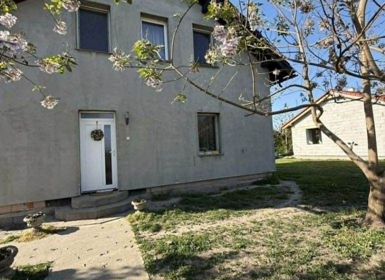 A family house in Dolný Štál surrounded by blooming trees and grass.