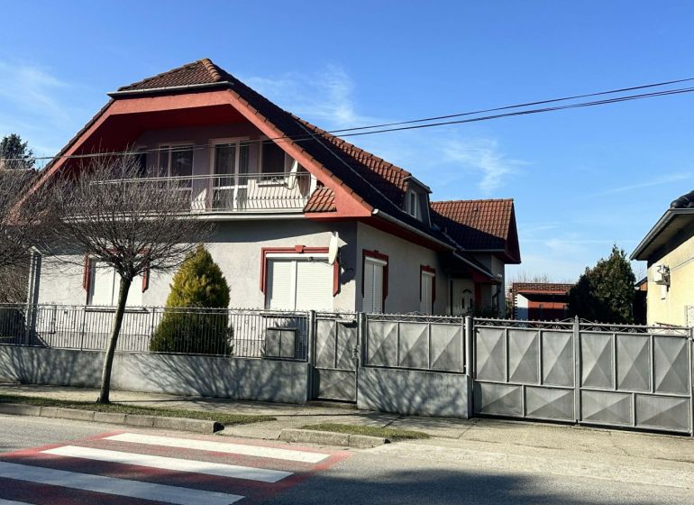 A family house in Dolný Štál with a traditional roof and a landscaped front garden.