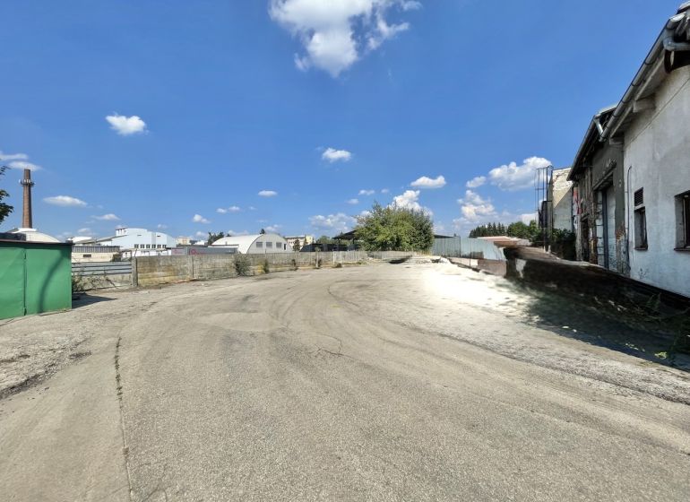 Paved area at the offices in Žilina with a view of the surrounding buildings and the sky.
