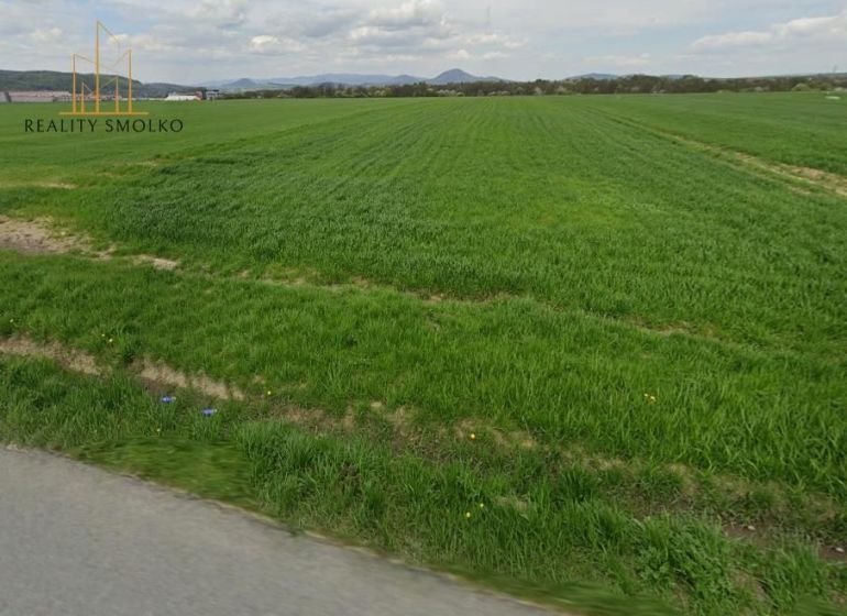 A vast green field suitable for residential plots around Záborské.