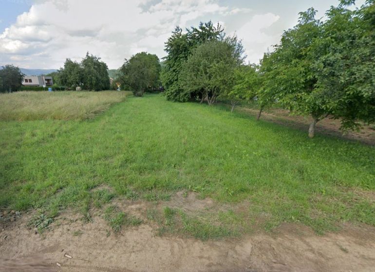 Land in Medzany suitable for living, with greenery and trees in the background.