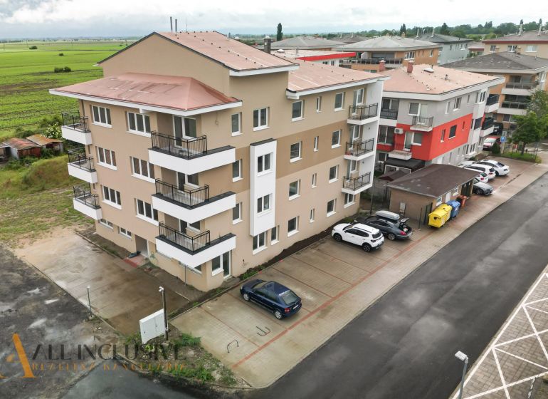 Apartment building in Senec on Dlhá Street with parked cars and surroundings.