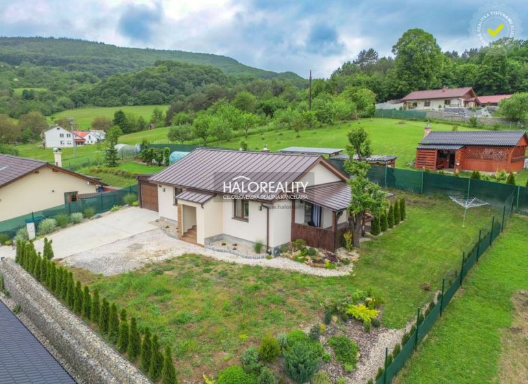 A family house in Dohňany with a pleasant garden, surrounded by greenery and hills in the background.