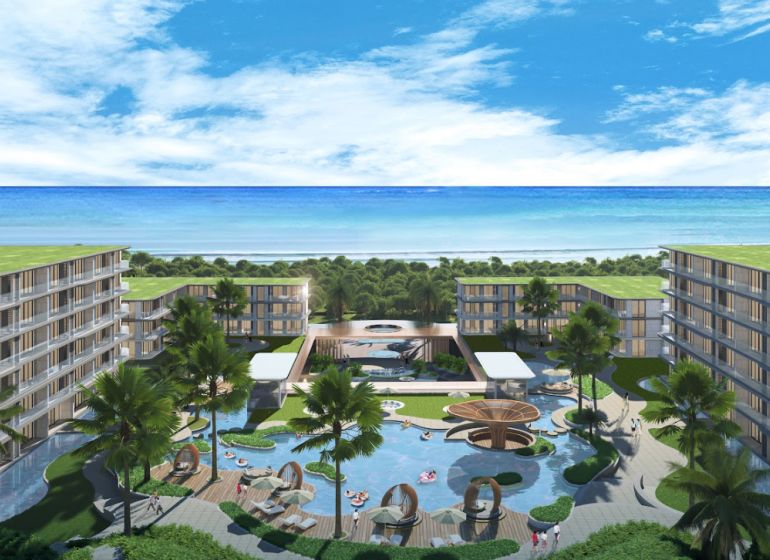 A view of apartment construction in Phuket by the beautiful coastline with palm trees.