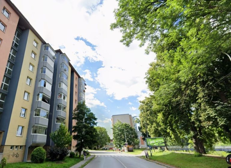 An apartment building on Nábrežná Street in Vrútky surrounded by greenery, suitable for 2-room apartments.