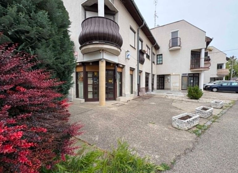 Commercial premises on Práce in Komárno with greenery and parking spaces.