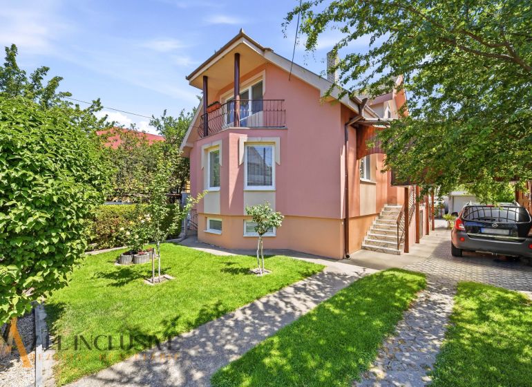 A family house in Gabčíkovo with a landscaped garden, garage, and sunny facades.