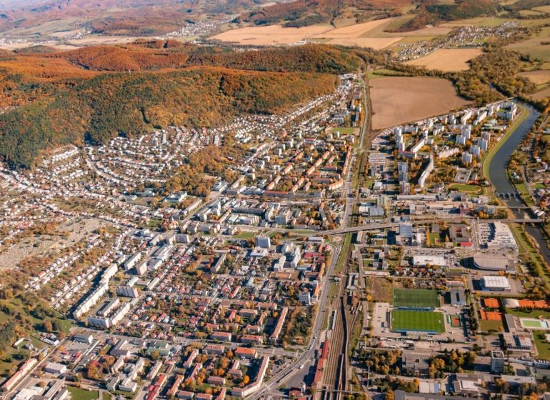 Aerial view of agricultural and forest land in Humenné with urban development.