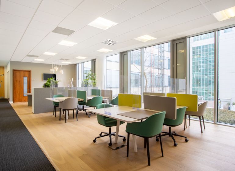 Bright offices with comfortable chairs and wood-patterned flooring.