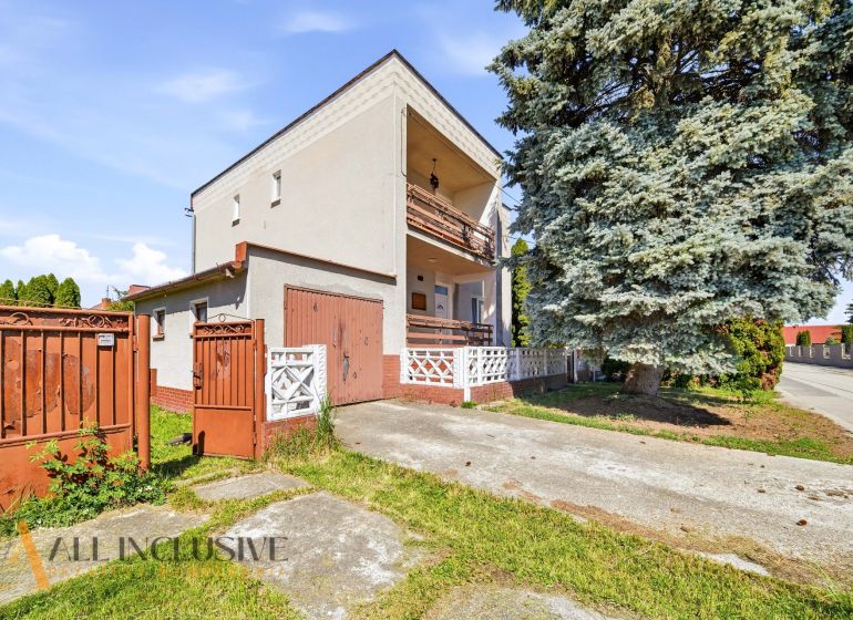 Family house in Topoľníky, fencing, gate, terrace, large tree in the yard.