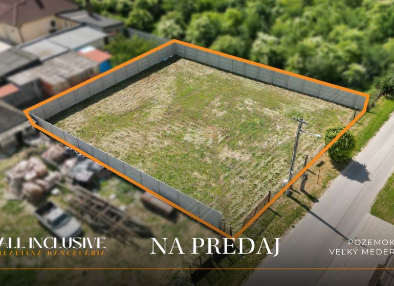 A residential plot in Veľký Meder, Ižop area, fenced and ready for construction.