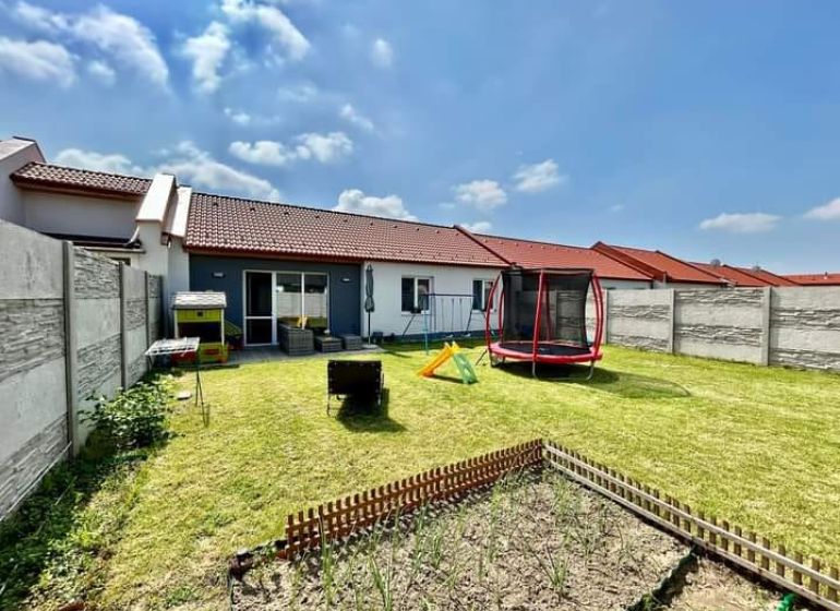A family house in Rajka with a lawn, a children's playground, and space for gardening.