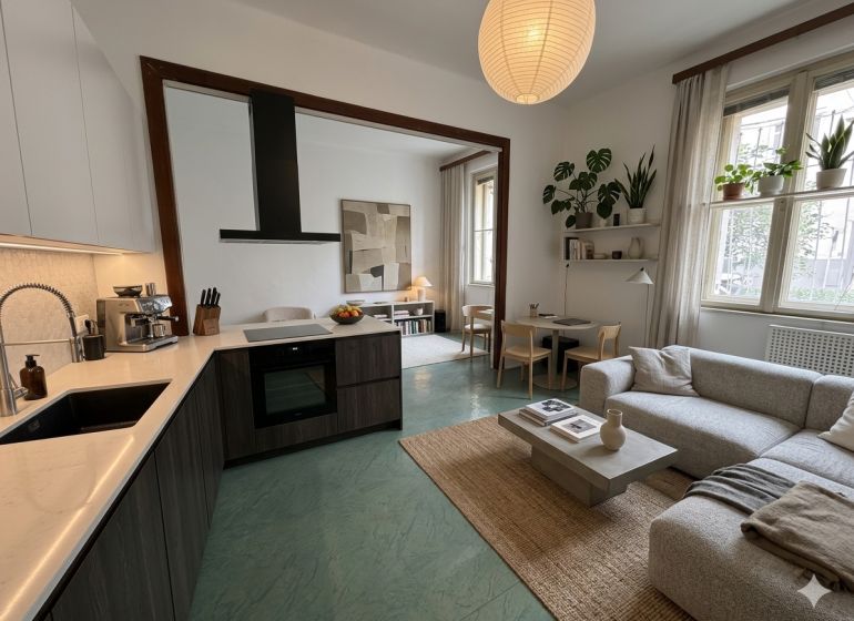 Spacious kitchen and living room in a 3-room apartment with a wooden decor floor.