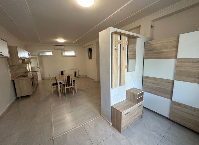 Bright kitchen area and dining nook with a table in a 3-room apartment.