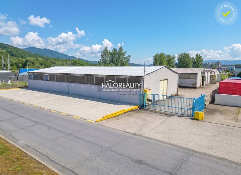 Production premises in Považská Bystrica with extensive outdoor parking and surrounding greenery.