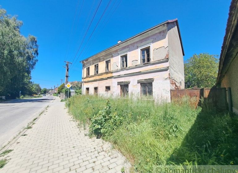 An abandoned family house in Klátova Nová Ves with damaged facade and overgrown land.