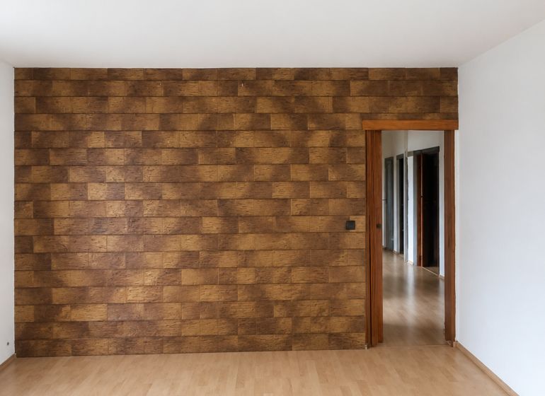 Interior of a 3-room apartment with a decorative wall and floor with a wooden decor.