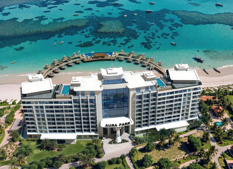 A hotel in Paje with a view of the turquoise sea and boats on the beach.