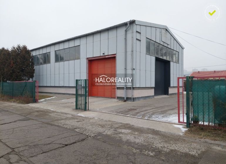 Warehouses and halls in the district of KE - Džungľa, with a metal structure and a red gate.