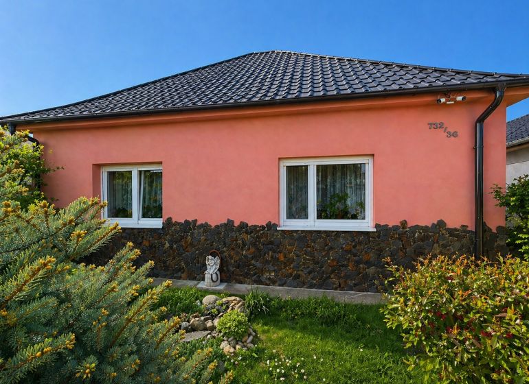 The family house on Nova Cesta in Jelka, Galanta district, has a pink facade and a tiled roof.