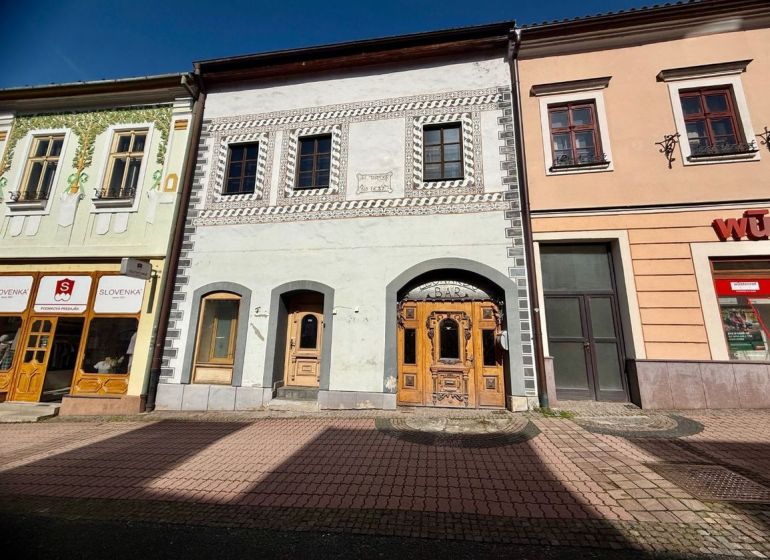 Dolná Street in Banská Bystrica features historic buildings with shops and a bar.