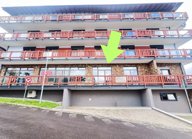 A building with balconies and a stone facade, commercial premises in Donovaly, Banská Bystrica district.