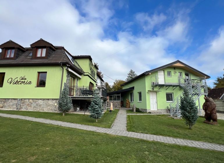 Villa in Štôla, Poprad District, Prešov Region, Slovakia, with a green facade and a meticulously maintained garden.