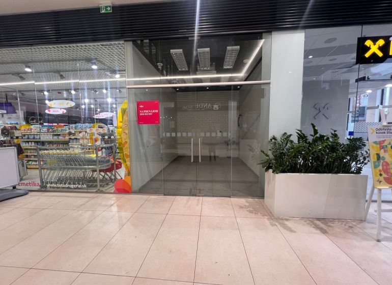 Commercial spaces with glazing and plants, next to the drugstore in the shopping center.