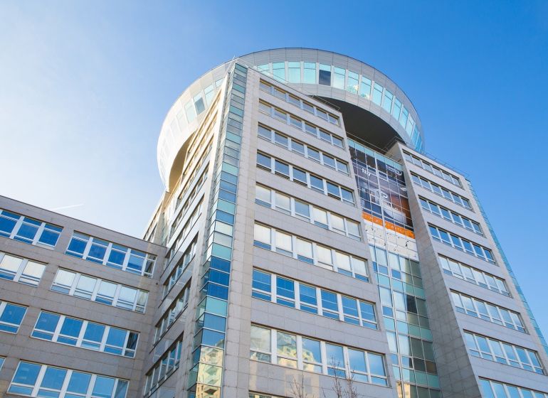 Office building on Plynárenská Street in Bratislava - Ružinov against the backdrop of a blue sky.