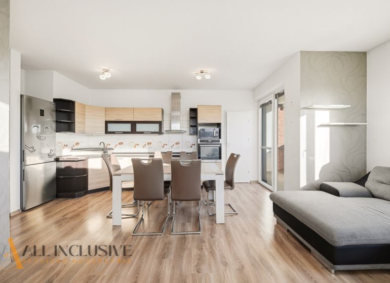A kitchen with a dining table in a 3-room apartment, floor with wood decor.