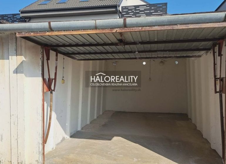 An empty garage in Senec with a roof and white walls.