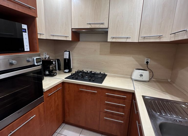 A kitchen with a corner unit and appliances in a 3-room apartment, ceramic tiles.