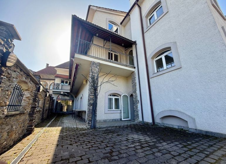 Mansion of peculiar real estate in Banská Bystrica with stone details and curb paving.