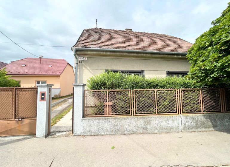 A family house on Krajinská Street in Bratislava - Podunajské Biskupice with a fence and a front garden.