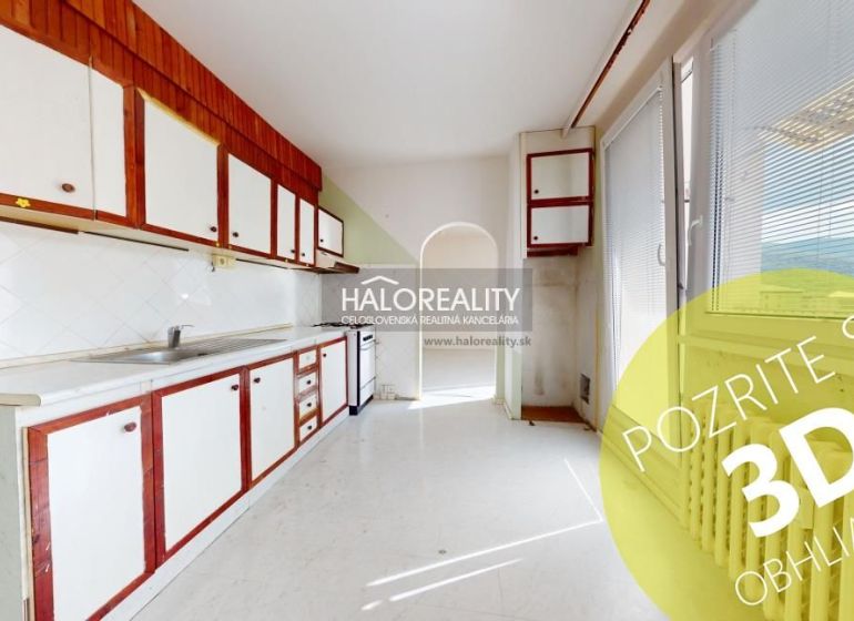 A kitchen in a 3-room apartment with older cabinets and balcony doors.