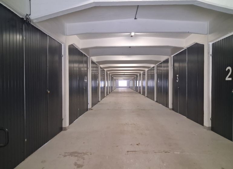 A long corridor with garage boxes in warehouses and halls.