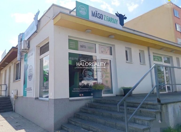 Commercial premises in Žiar nad Hronom with advertisements for farm meat and an entrance staircase.